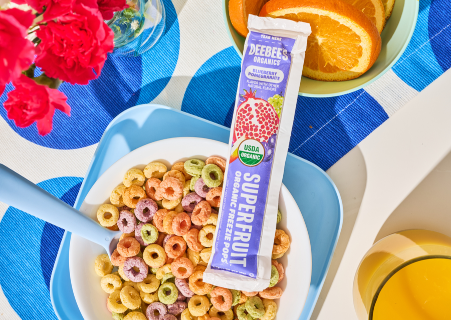 DeeBee's Organics Blueberry Pomegranate SuperFruit Freezie Pop with cereal, oranges, and juice.