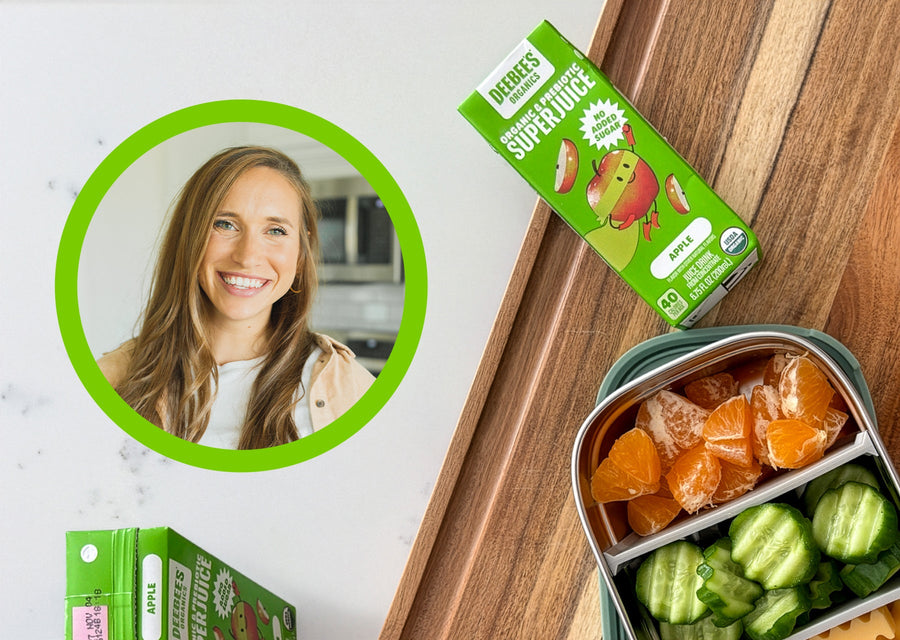 Headshot of Toddler Dietitian Tiffany Walla beside DeeBee's Organics Apple SuperJuice Prebiotic Juice Box and a healthy lunch container with oranges and cucumbers.