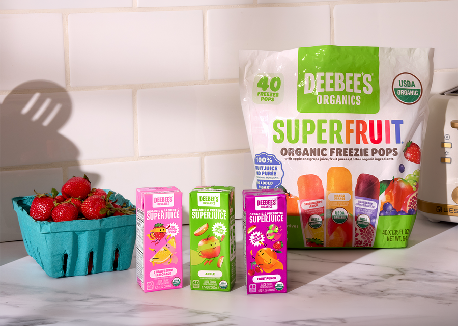 DeeBee’s Organics SuperFruit Freezies 40 pack with organic SuperJuice boxes and fresh strawberries on a kitchen counter